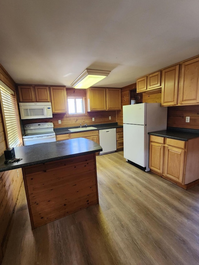11359 Polaris St, Saint Helen, MI 48656 - kitchen with white appliances, light wood-style flooring, dark countertops, and a peninsula