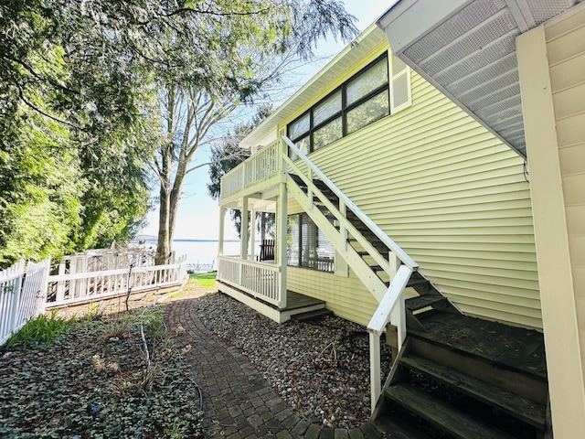 6382 W Higgins Lake Dr, Roscommon, MI 48653 - view of side of home featuring fence and a water view
