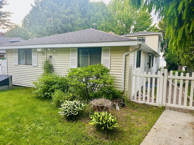 6382 W Higgins Lake Dr, Roscommon, MI 48653 - view of front of property featuring a shingled roof and a gate