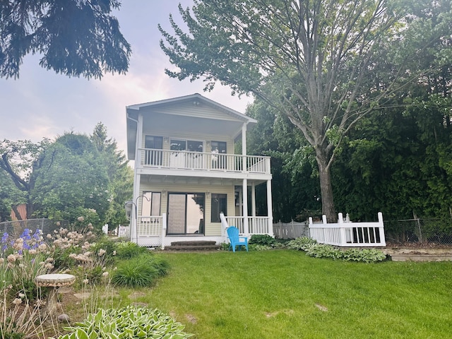 6382 W Higgins Lake Dr, Roscommon, MI 48653 - back of house with a balcony and a porch