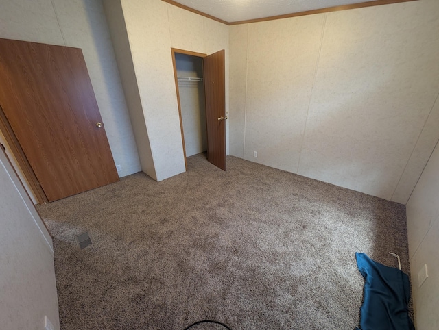 20776 Tennis Rd, Hillman, MI 49746 - unfurnished bedroom with visible vents, carpet floors, and a closet