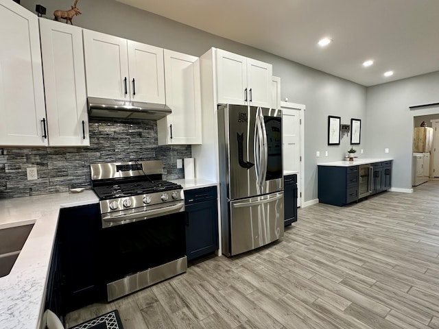 kitchen featuring recessed lighting, decorative backsplash, stainless steel appliances, under cabinet range hood, and light wood-type flooring
