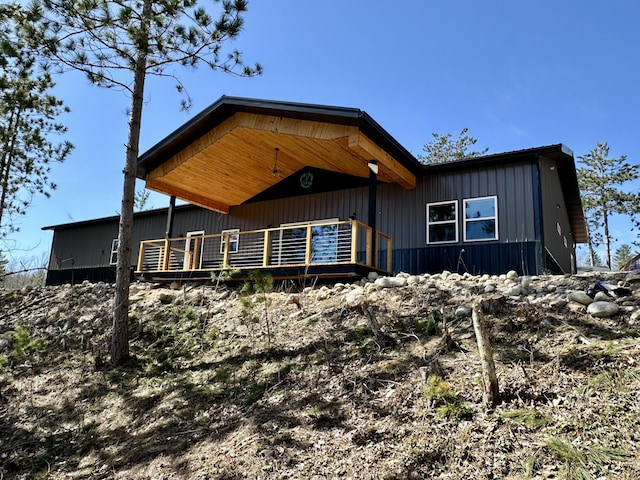 view of front of home featuring board and batten siding and a wooden deck