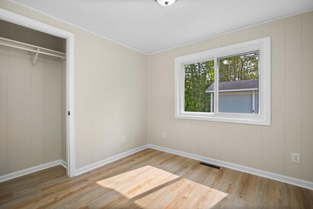 12320 E Houghton Lake Dr, Houghton Lake, MI 48629 - unfurnished bedroom with wood finished floors, a closet, and ornamental molding