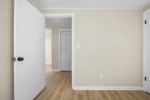 12320 E Houghton Lake Dr, Houghton Lake, MI 48629 - spare room featuring light wood-style flooring and ornamental molding