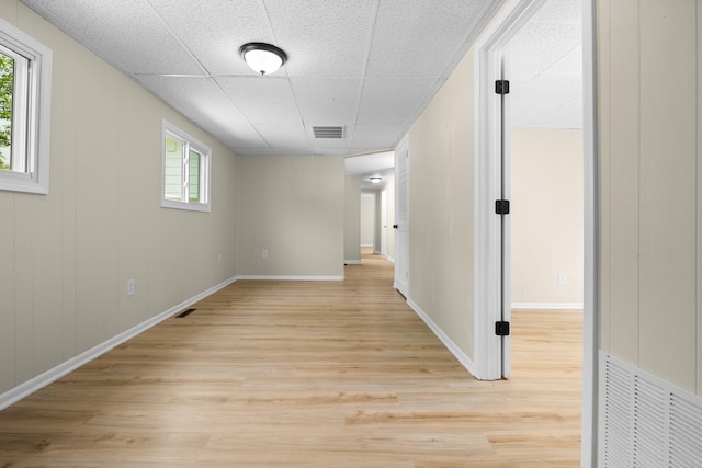 12320 E Houghton Lake Dr, Houghton Lake, MI 48629 - hall with light wood finished floors, plenty of natural light, and a drop ceiling