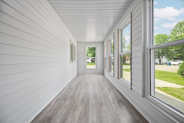 12320 E Houghton Lake Dr, Houghton Lake, MI 48629 - unfurnished sunroom featuring wood finished floors, healthy amount of natural light, and wooden walls