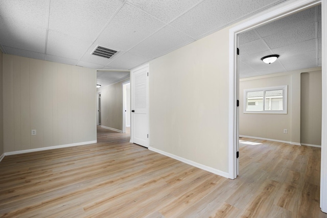 12320 E Houghton Lake Dr, Houghton Lake, MI 48629 - unfurnished room featuring a drop ceiling and light wood-type flooring