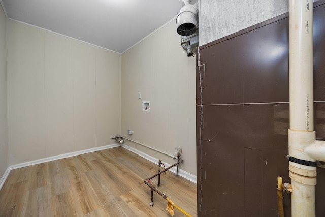 12320 E Houghton Lake Dr, Houghton Lake, MI 48629 - laundry room featuring ornamental molding, wood finished floors, and washer hookup
