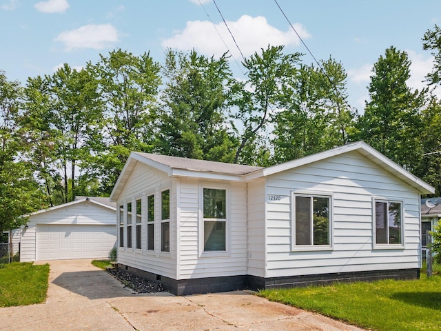12320 E Houghton Lake Dr, Houghton Lake, MI 48629 - view of front of home with a garage, an outdoor structure, and crawl space