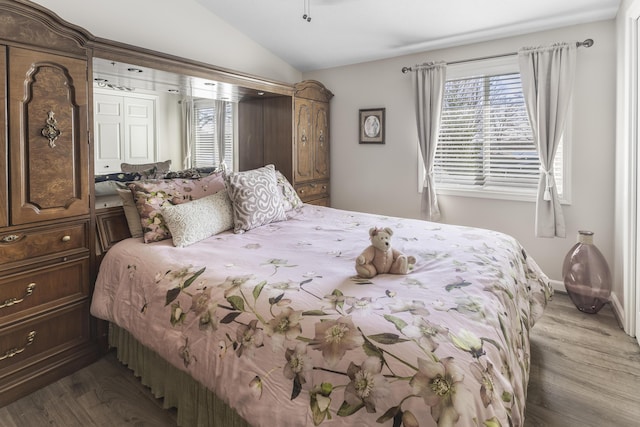 6150 Northpoint Dr, Saint Helen, MI 48656 - bedroom featuring wood finished floors and vaulted ceiling