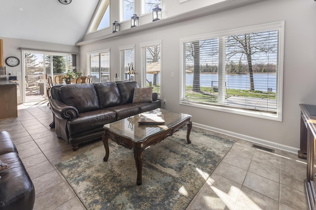 6150 Northpoint Dr, Saint Helen, MI 48656 - tiled living room featuring plenty of natural light, a water view, and high vaulted ceiling