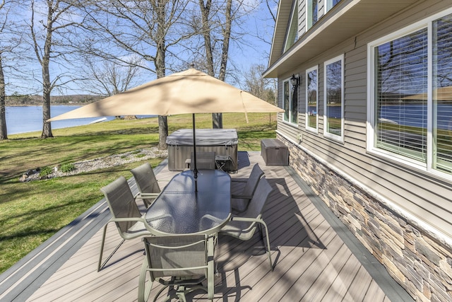 6150 Northpoint Dr, Saint Helen, MI 48656 - wooden terrace featuring a hot tub, outdoor dining space, a water view, and a lawn