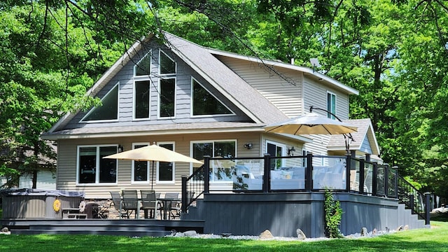 6150 Northpoint Dr, Saint Helen, MI 48656 - rear view of property featuring a deck, roof with shingles, a lawn, and stairway