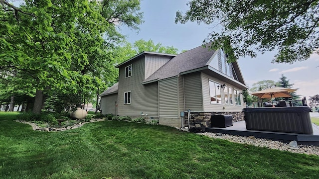 6150 Northpoint Dr, Saint Helen, MI 48656 - view of side of property featuring a hot tub, a lawn, and roof with shingles