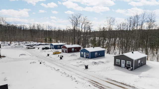 635 Gazelle St, Gaylord, MI 49735 - snowy aerial view featuring a wooded view