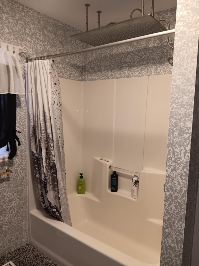 bathroom with a combined bath / shower with rainfall shower
