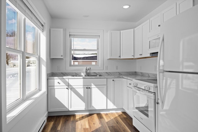 598 Gazelle St, Gaylord, MI 49735 - kitchen featuring a sink, white appliances, white cabinetry, dark wood-type flooring, and light stone counters