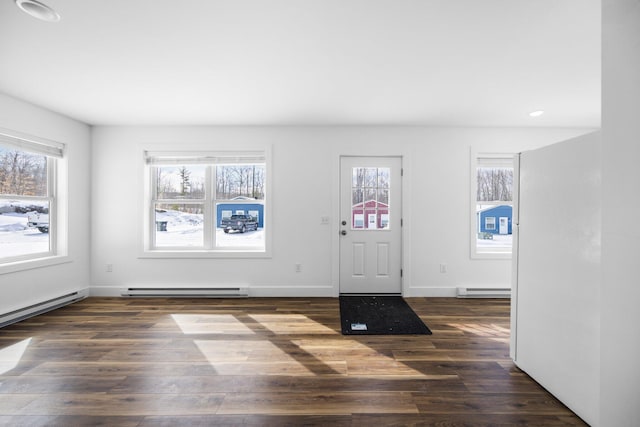 598 Gazelle St, Gaylord, MI 49735 - foyer entrance with wood finished floors, a baseboard heating unit, and a wealth of natural light