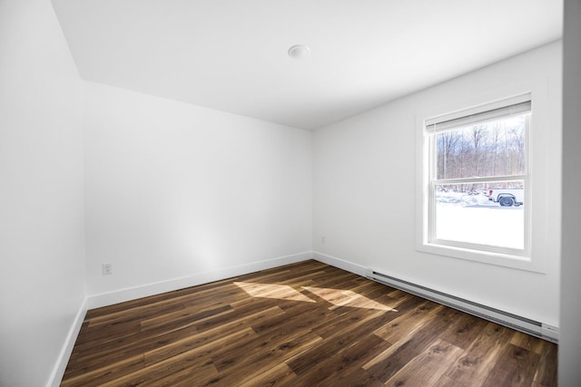 598 Gazelle St, Gaylord, MI 49735 - empty room with dark wood-type flooring, baseboards, and a baseboard heating unit