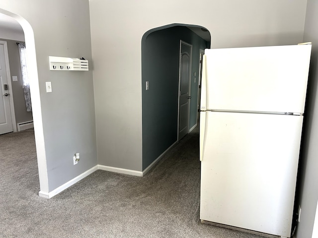 corridor with arched walkways, carpet flooring, and baseboards