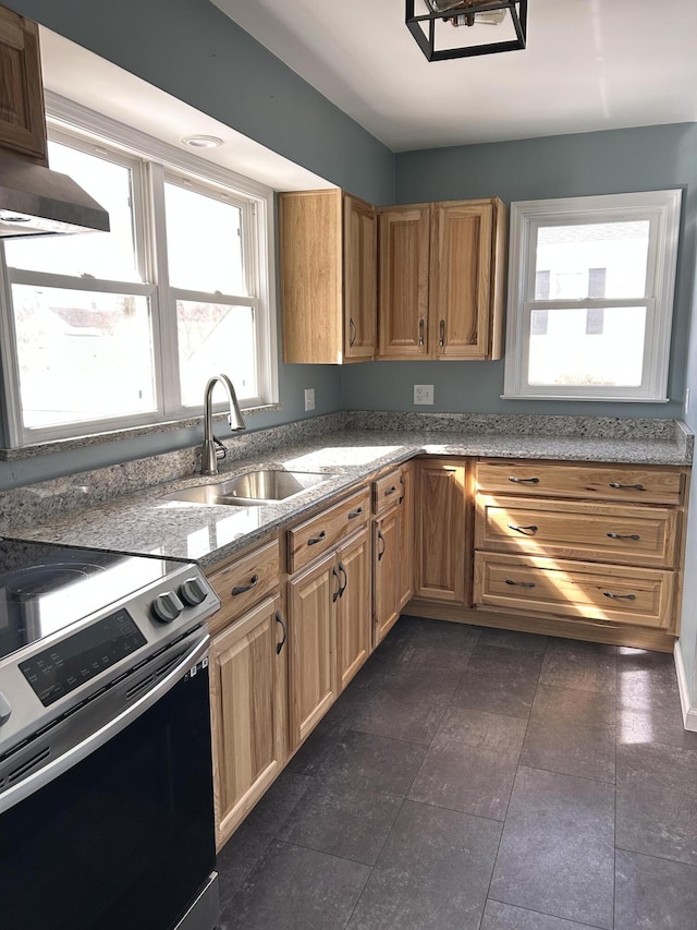 kitchen featuring stone counters, a sink, stainless steel electric stove, and wall chimney exhaust hood