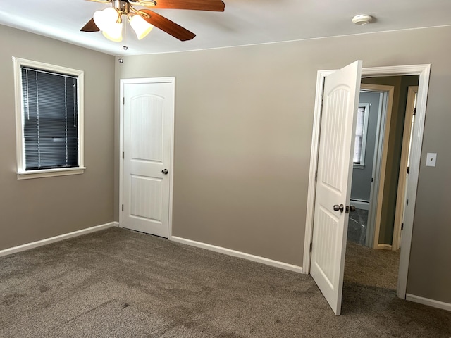 unfurnished bedroom featuring baseboard heating, ceiling fan, baseboards, and carpet floors