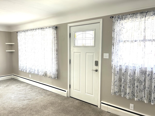 carpeted entrance foyer featuring a baseboard heating unit