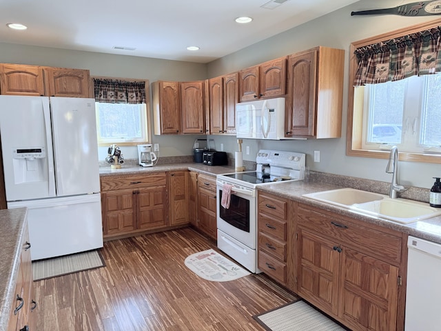 kitchen with white appliances, visible vents, plenty of natural light, and a sink
