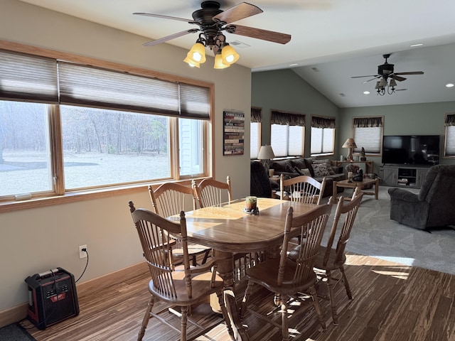 dining area with ceiling fan, wood finished floors, and lofted ceiling