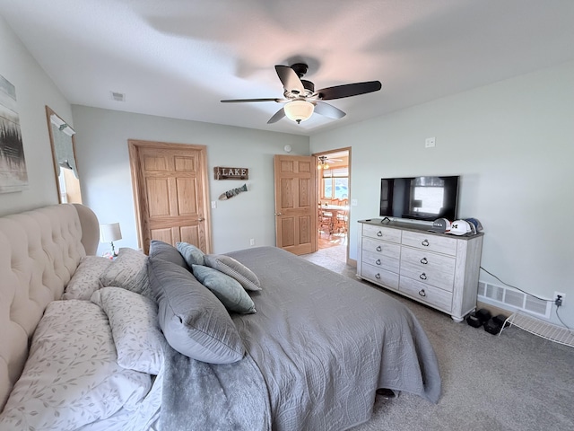 bedroom featuring carpet floors, a ceiling fan, and visible vents