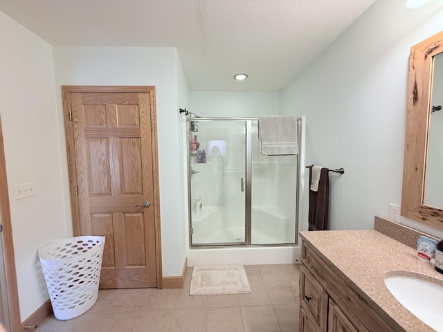 full bathroom featuring vanity, baseboards, a stall shower, and recessed lighting