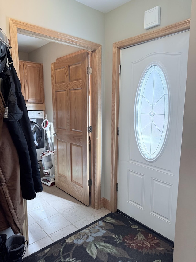 entryway with light tile patterned flooring and washer / dryer