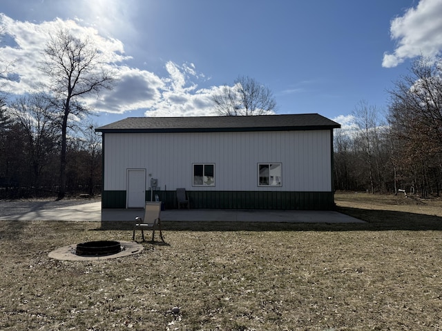 view of outbuilding with a fire pit