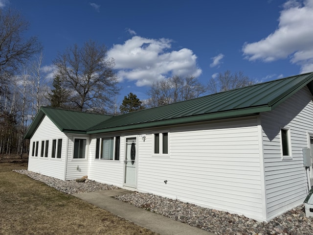 view of property exterior featuring metal roof