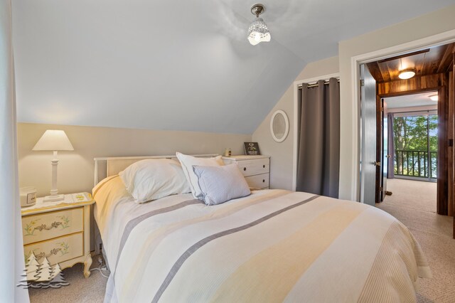 bedroom featuring carpet floors and lofted ceiling