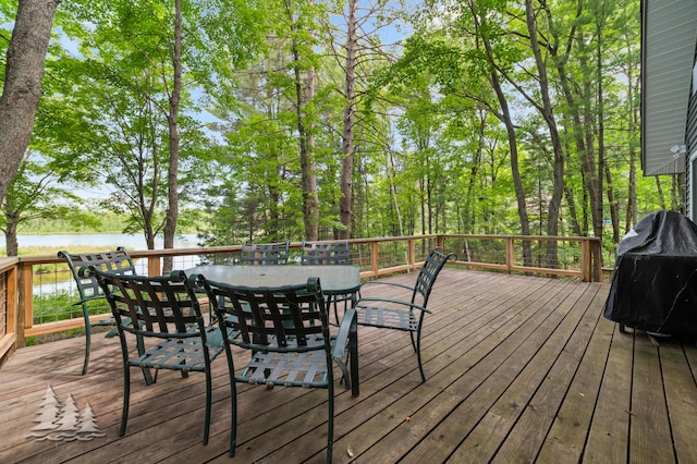 deck featuring a water view, grilling area, and outdoor dining space