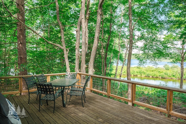 wooden deck featuring a water view and outdoor dining space