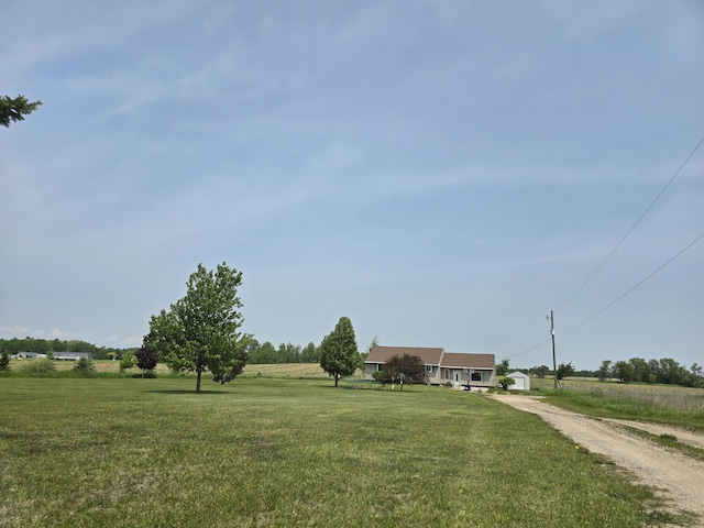 626 W Finerty Rd, West Branch, MI 48661 - view of front of property featuring a front yard, dirt driveway, and a view of rural / pastoral area