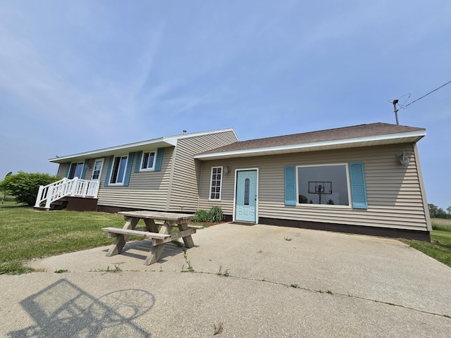 626 W Finerty Rd, West Branch, MI 48661 - back of property featuring a lawn and driveway