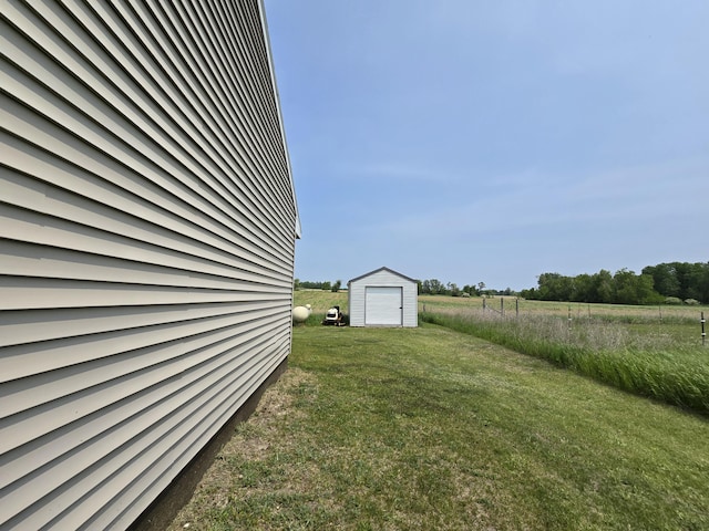 626 W Finerty Rd, West Branch, MI 48661 - view of green lawn with a storage shed, a view of countryside, and a garage
