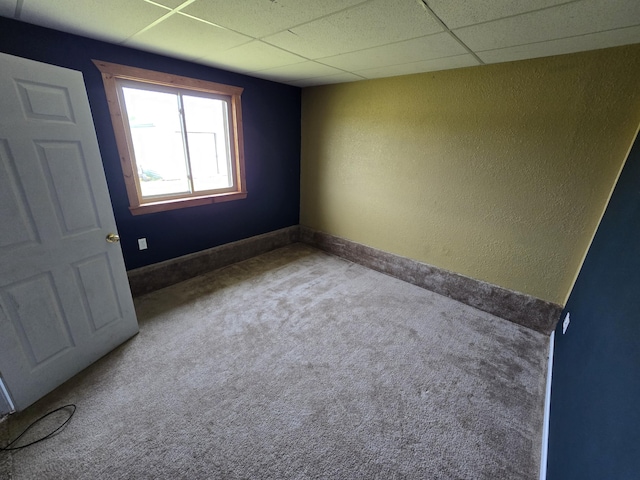 626 W Finerty Rd, West Branch, MI 48661 - unfurnished room featuring carpet, a paneled ceiling, and a textured wall