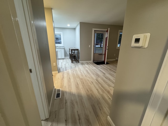 corridor with recessed lighting, light wood-style floors, baseboards, and visible vents