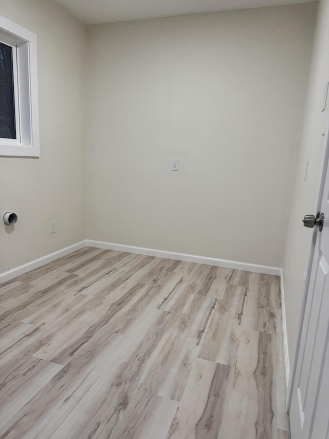 unfurnished room featuring wood finished floors and baseboards
