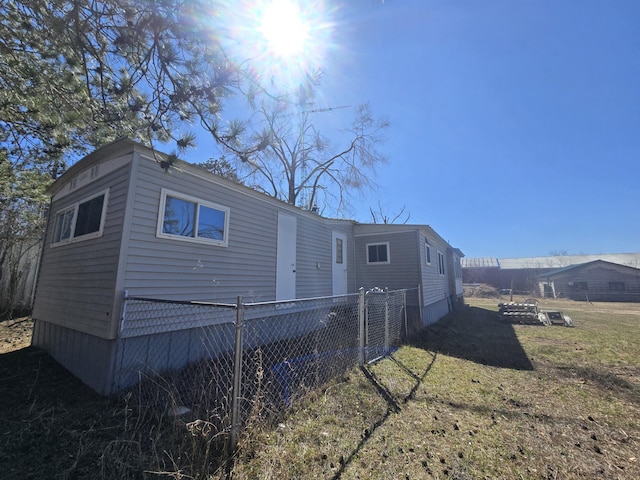 2051 Stutesman Dr, Fairview, MI 48621 - view of home's exterior featuring fence