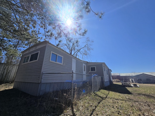 2051 Stutesman Dr, Fairview, MI 48621 - view of property exterior featuring fence and a lawn