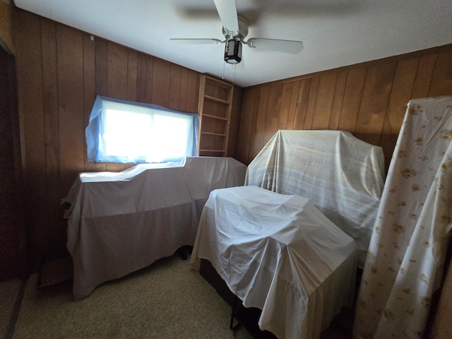 2051 Stutesman Dr, Fairview, MI 48621 - bedroom featuring wood walls, light carpet, and ceiling fan