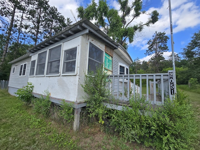 2051 Stutesman Dr, Fairview, MI 48621 - view of property exterior featuring a wooden deck
