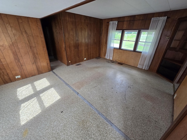 2051 Stutesman Dr, Fairview, MI 48621 - unfurnished room featuring wooden walls and carpet flooring