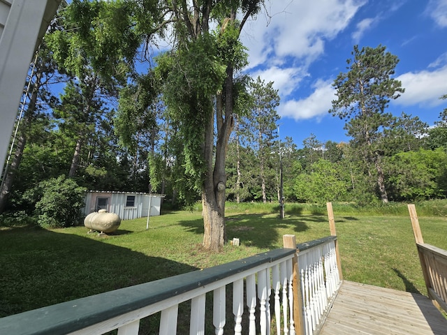 2051 Stutesman Dr, Fairview, MI 48621 - view of grassy yard with an outbuilding and a wooden deck